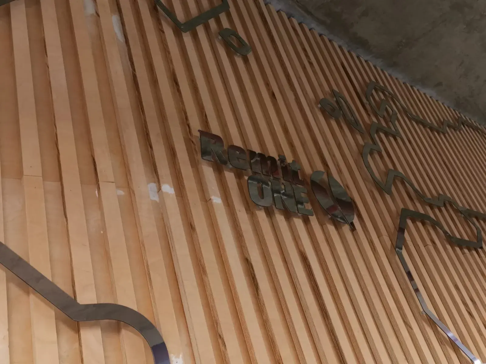 Remit One built-up lettering mounted to timber wall slats — 3D Built-Up Letters example for Chelsea SW3