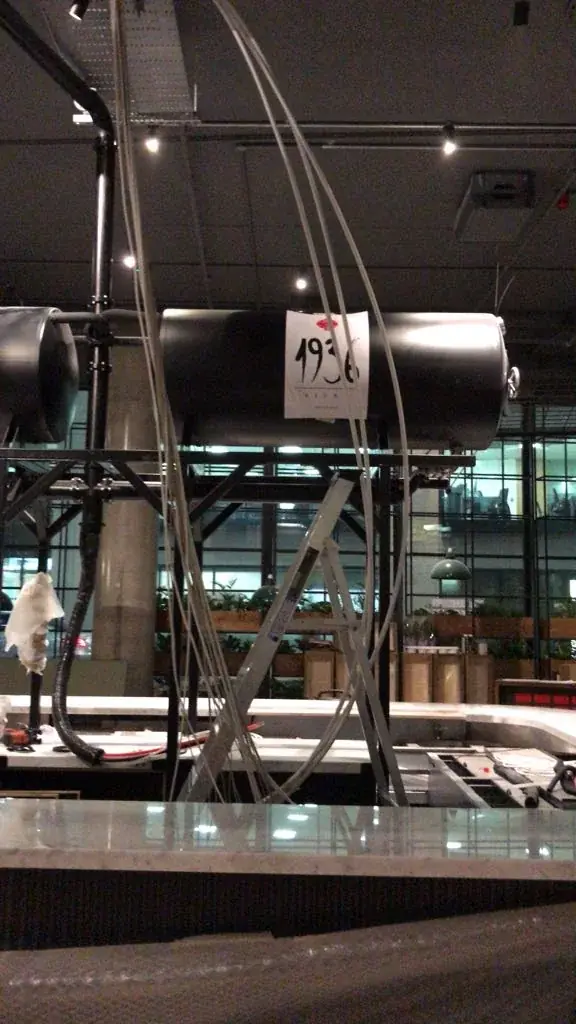 Portrait view of a branded 1936 Bière tank during venue installation, gallery image 19