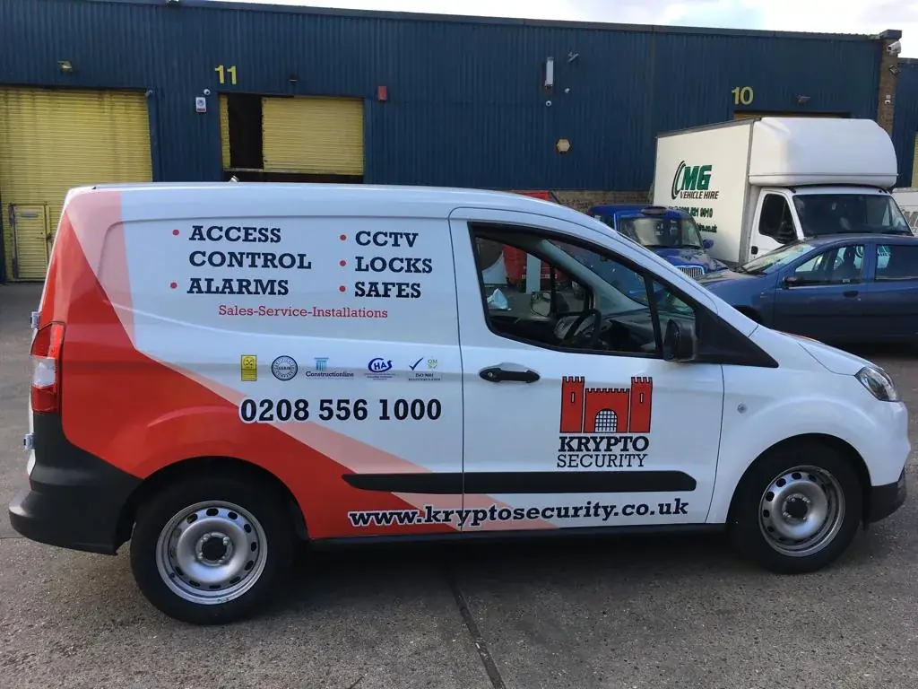 Full side view of a Krypto Security van with red, white and black commercial graphics