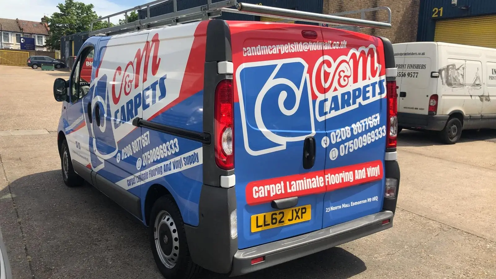 Rear-quarter view of the C&M Carpets van with coordinated side and rear graphics