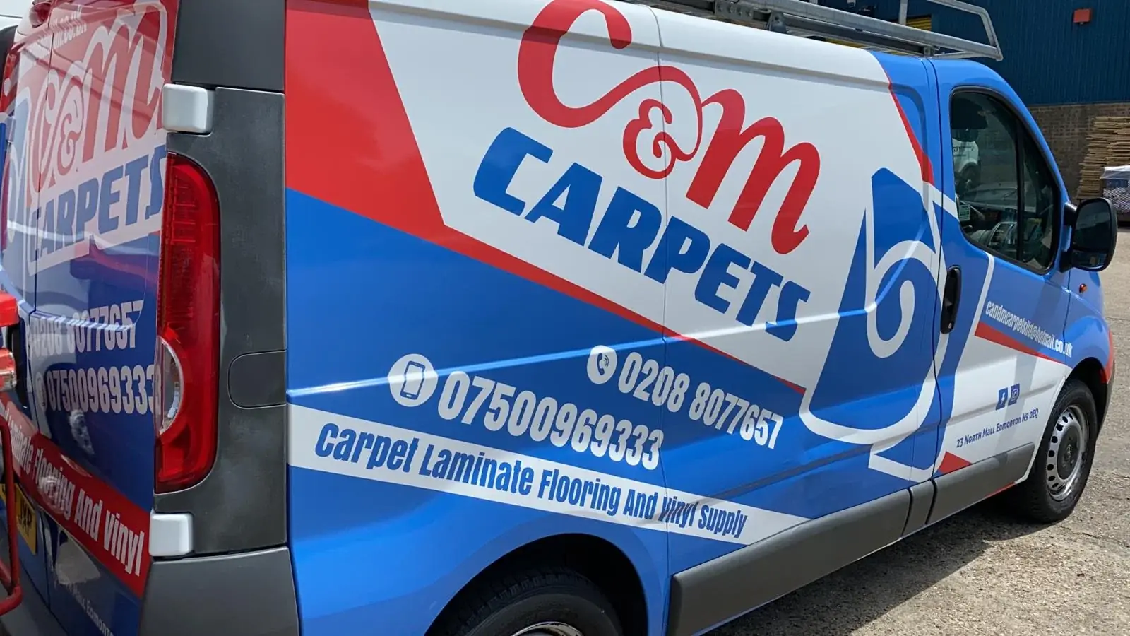 Detailed view of C&M Carpets side graphics, service lettering and contact details