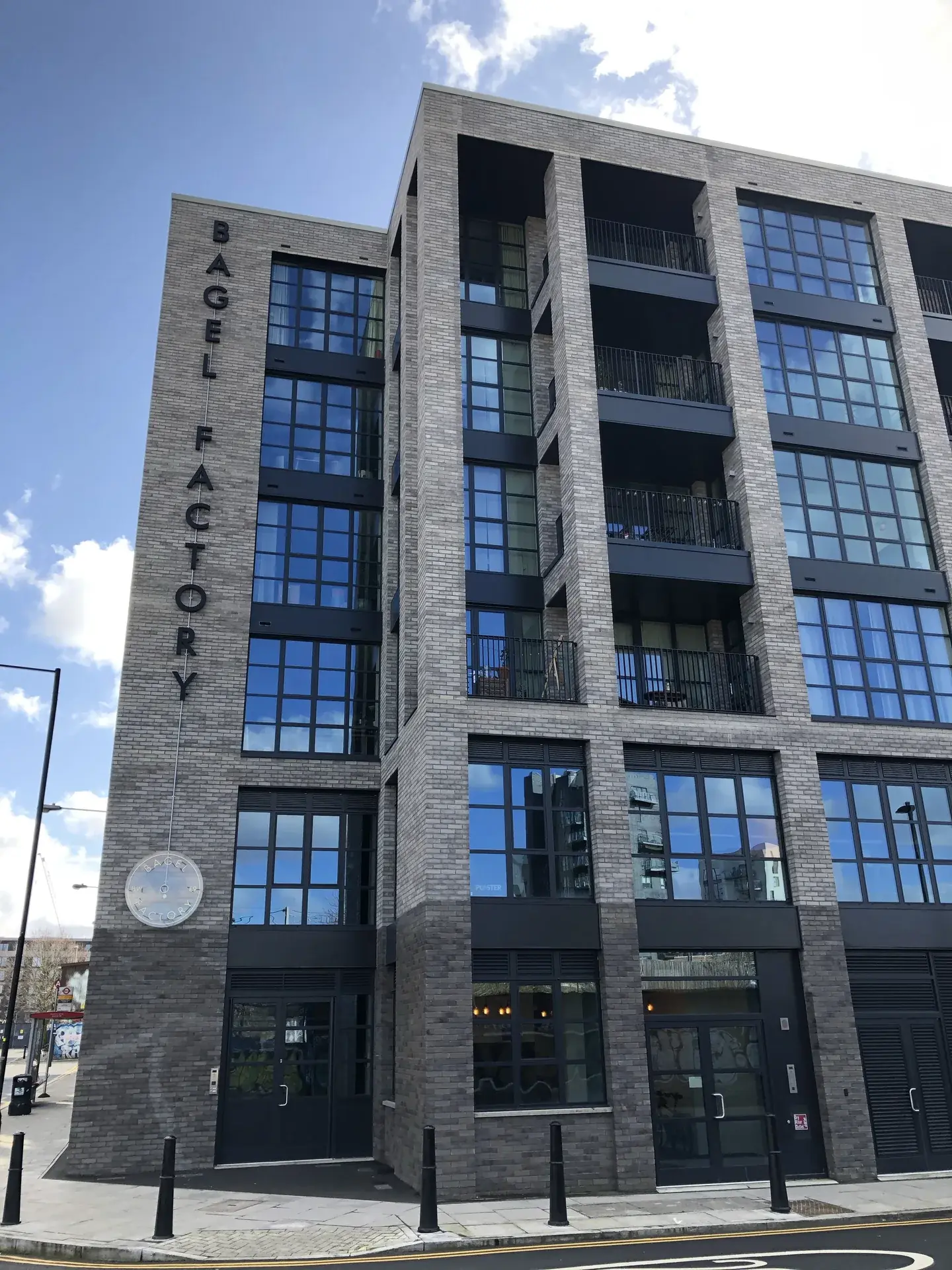 Full-height view of the Bagel Factory exterior 3D lettering installation