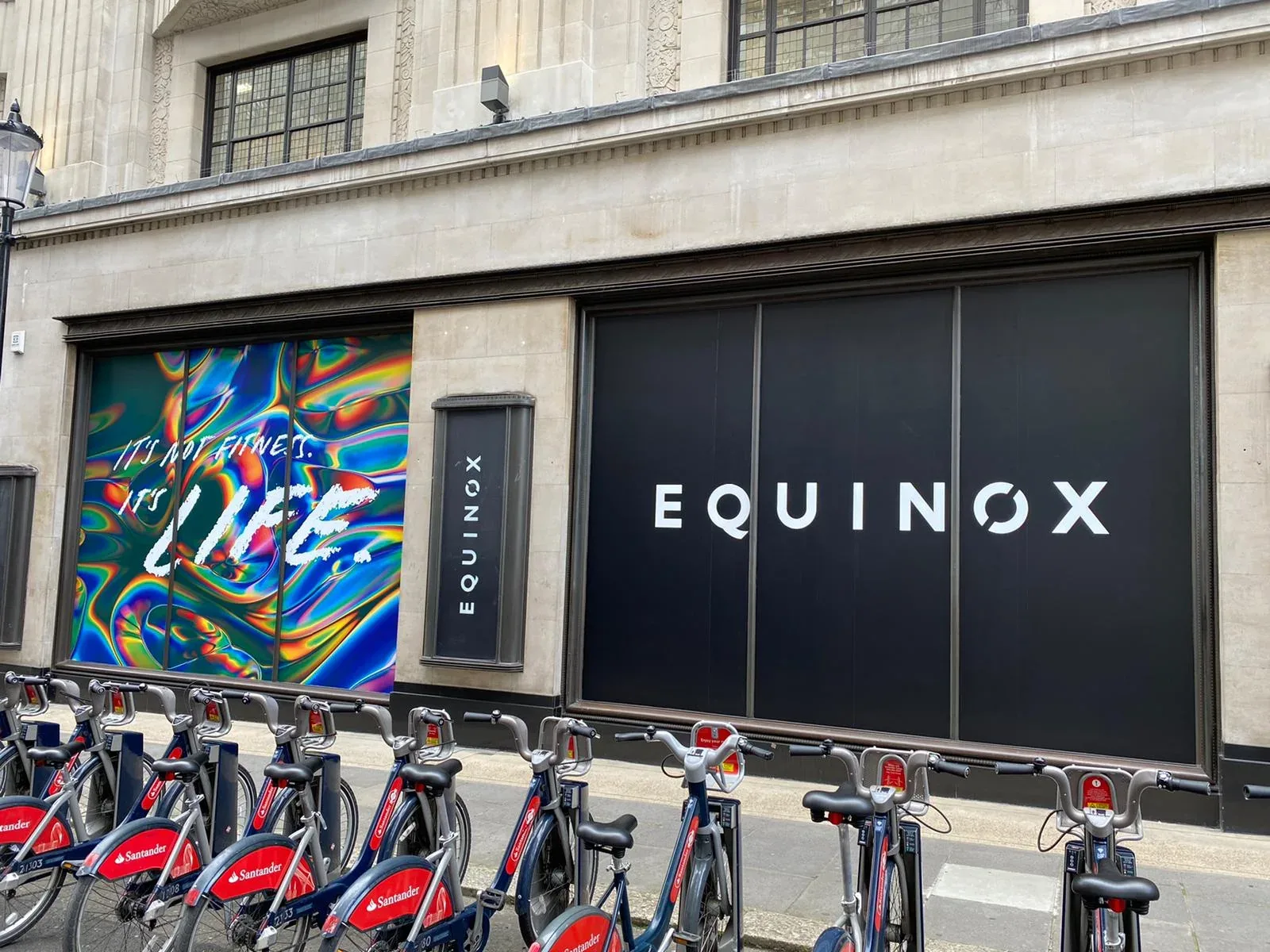Wide black window treatment with central white Equinox identity