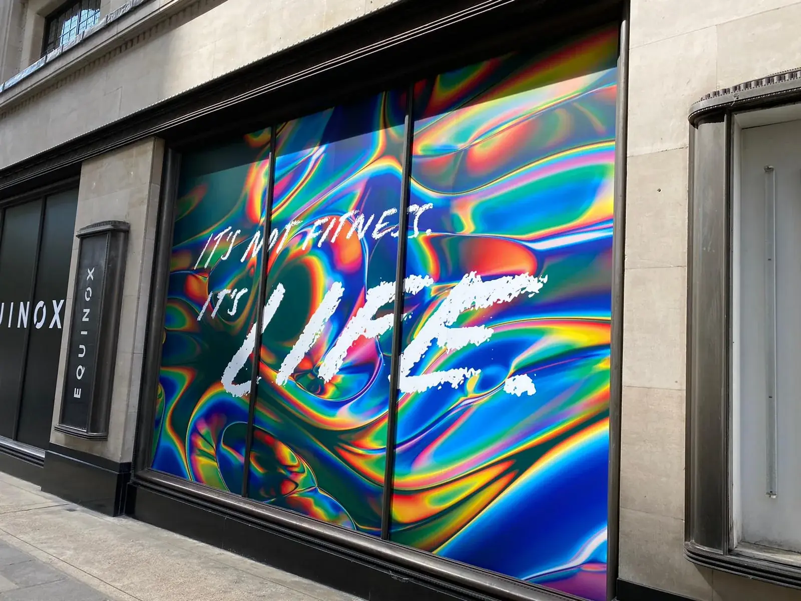 Angled view of vivid Equinox campaign artwork spanning the full window