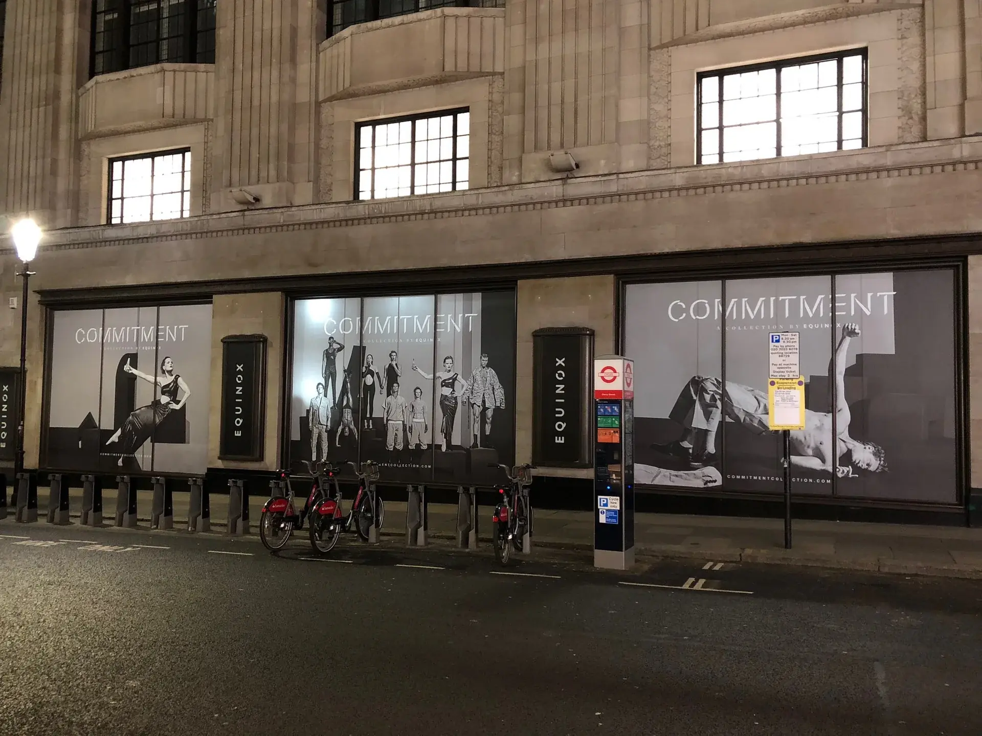 Equinox Kensington frontage covered with black-and-white Commitment campaign window graphics — selected project for Hackney E8