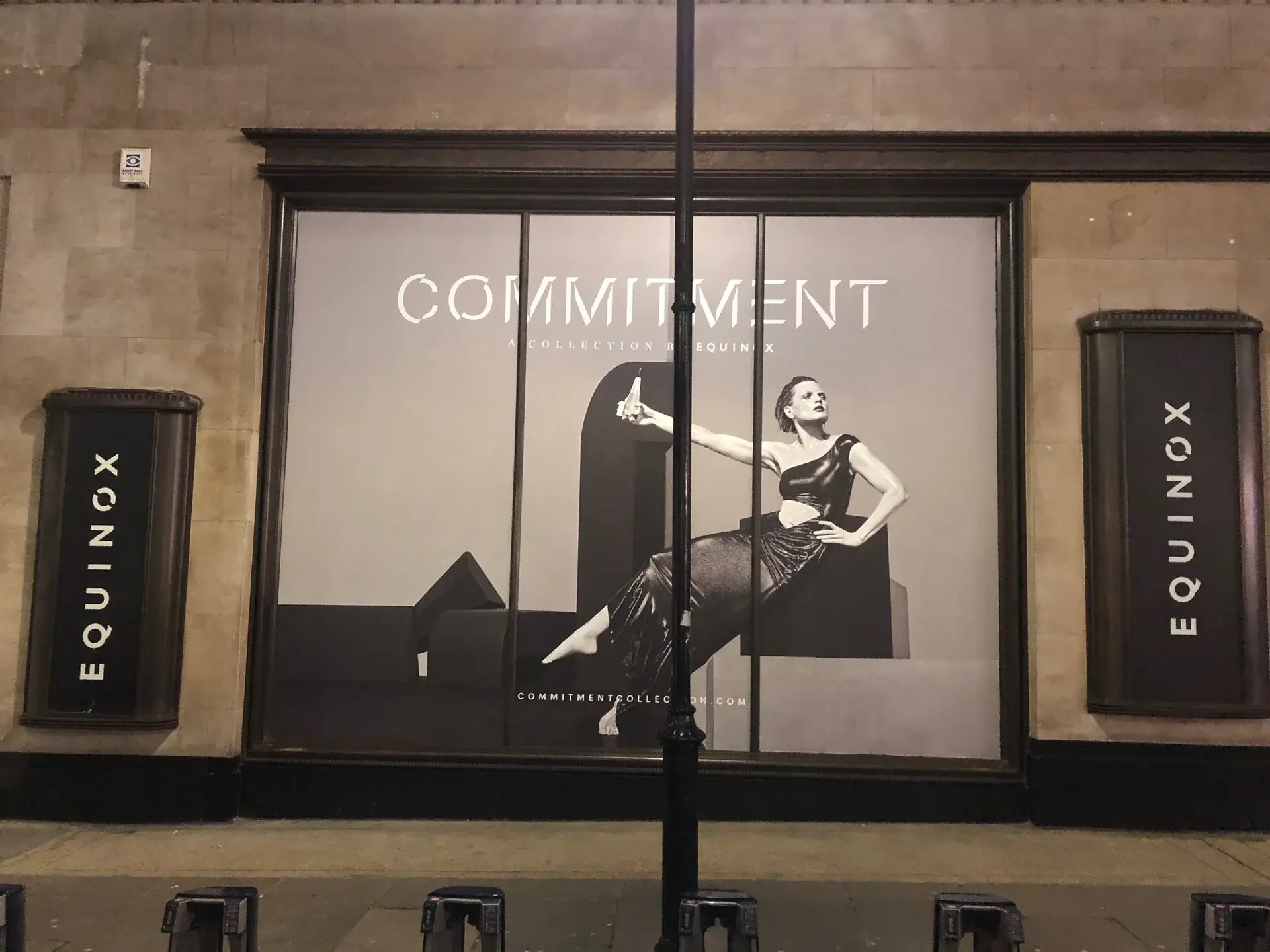 Equinox Commitment window graphic featuring a seated model