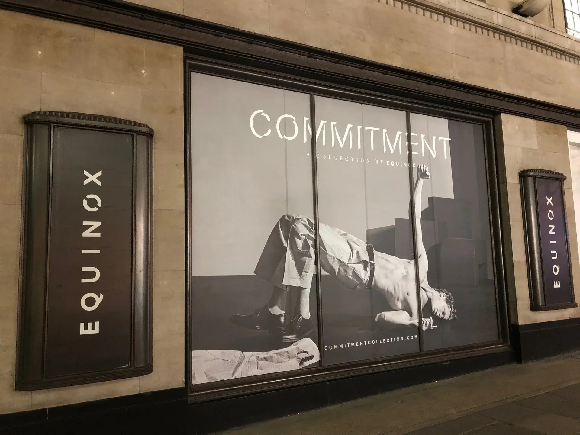 Angled view of Equinox Kensington full-window campaign graphics