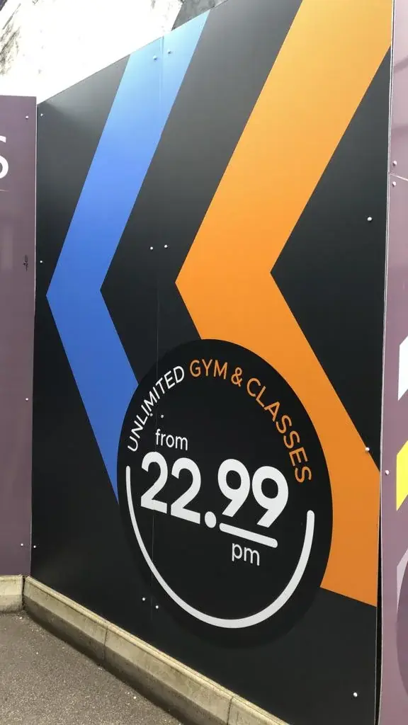 Orange and blue Fitness4Less chevron graphics with a circular price message