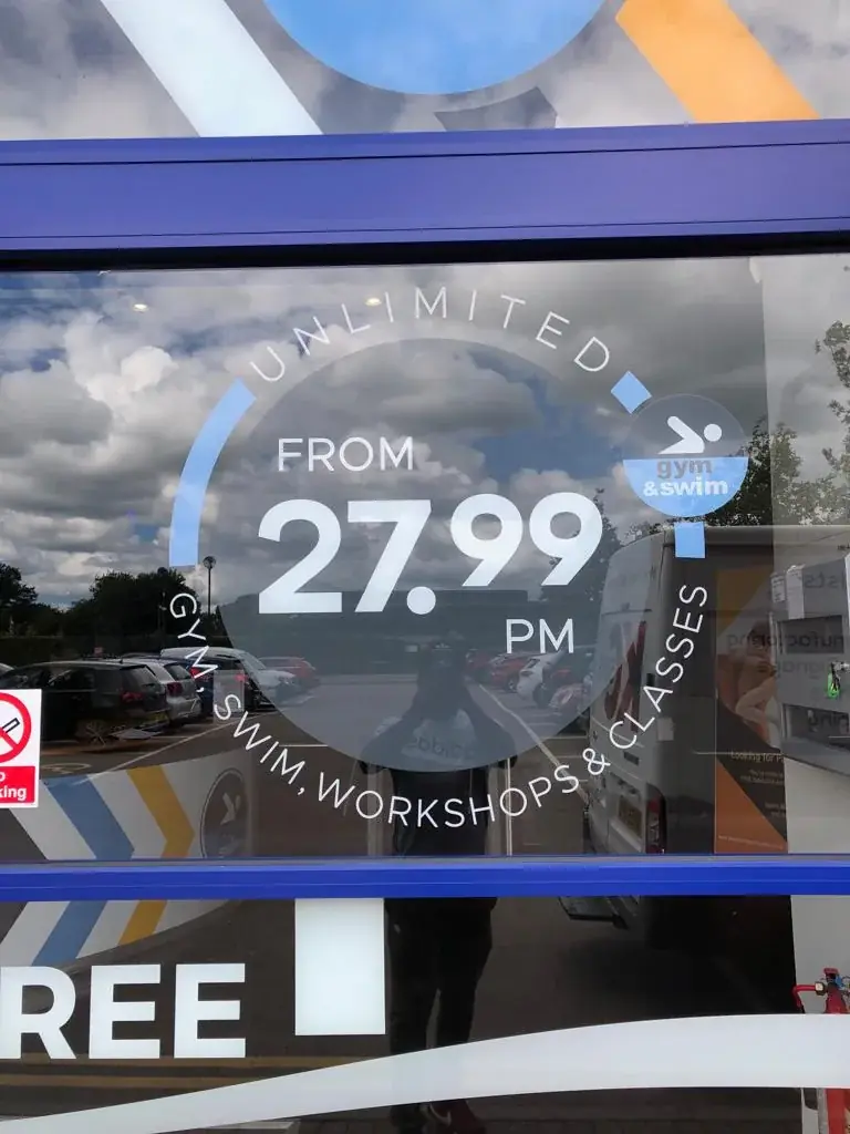 Gym and Swim 27.99 promotional window graphic with circular lettering