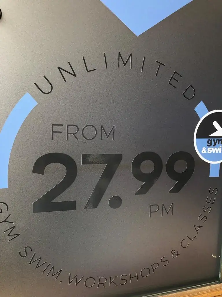 Frosted Gym and Swim membership price graphic applied to glass