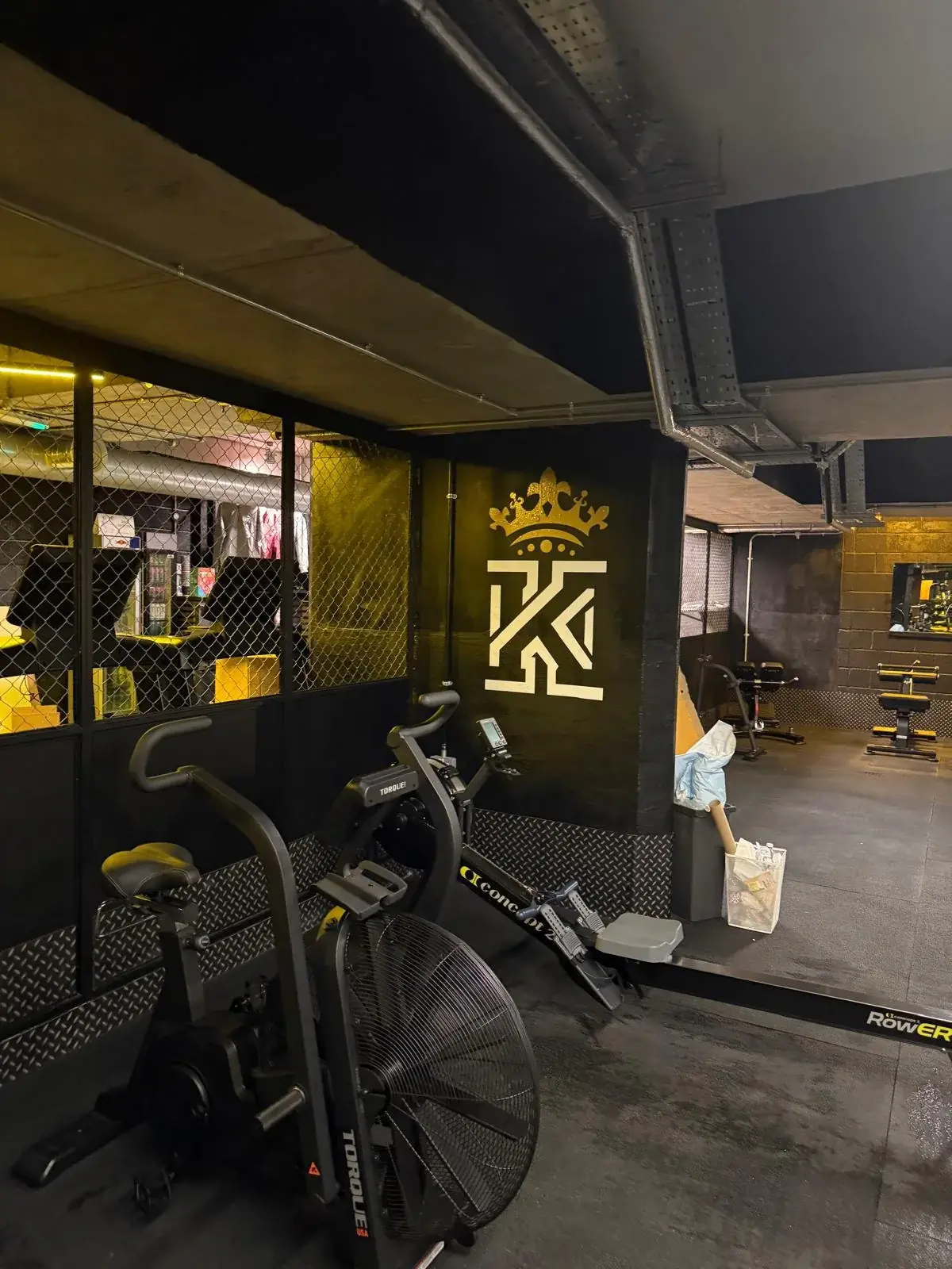Kings Gym crown and K wall graphic beside cardio equipment in the completed Tower Bridge gym