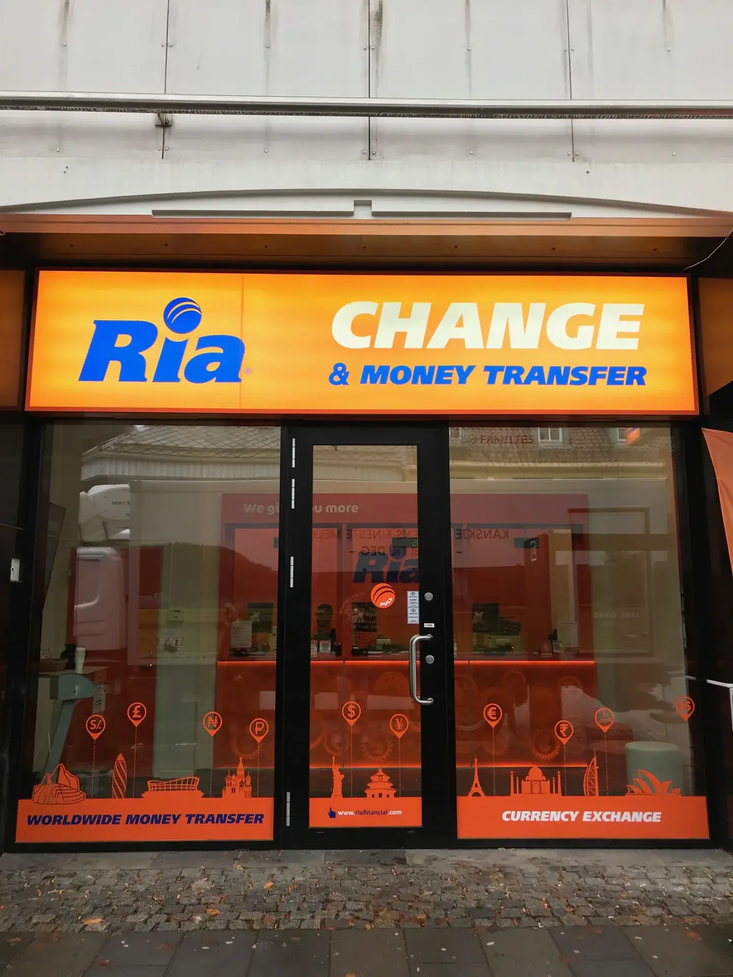 Front view of the illuminated Ria Change and Money Transfer fascia sign