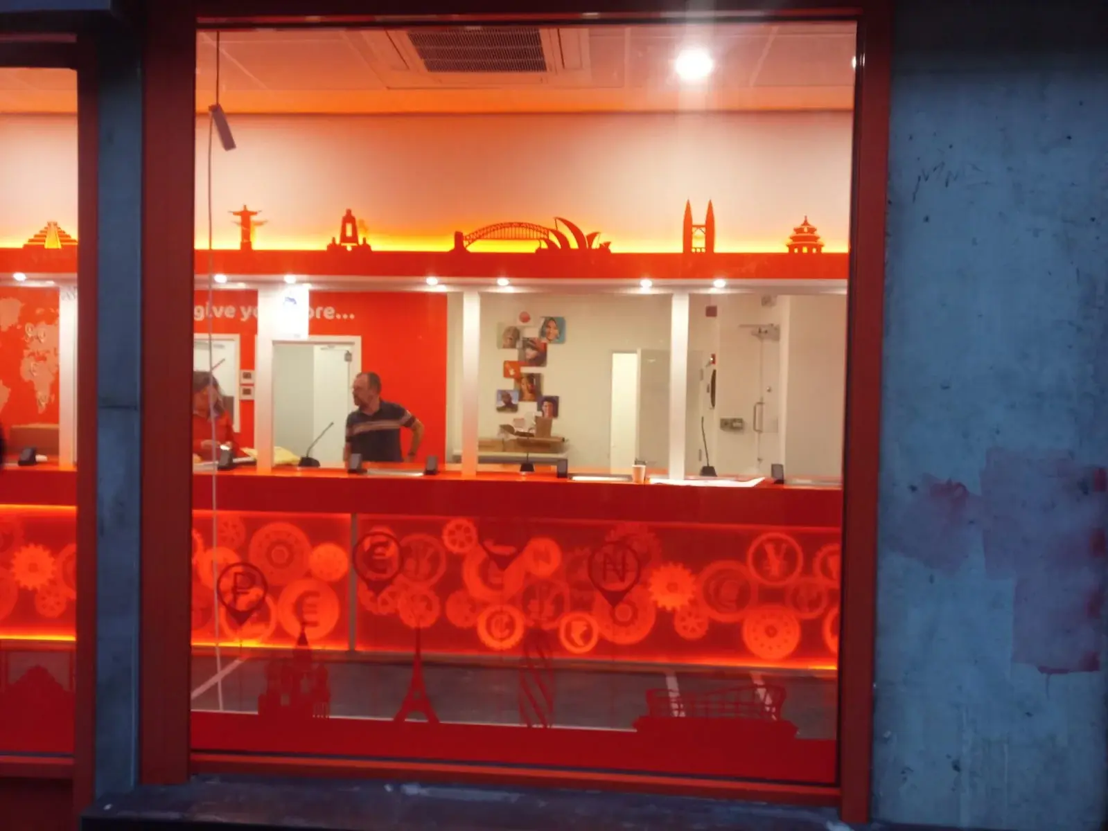 Completed Ria service counter with illuminated orange graphic panels