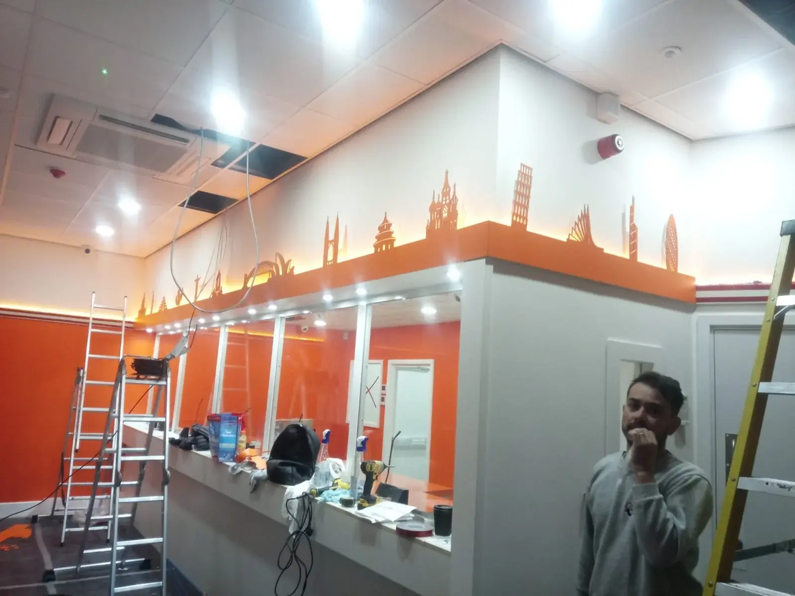 Ria customer-service counter and glass screens during the interior fit-out