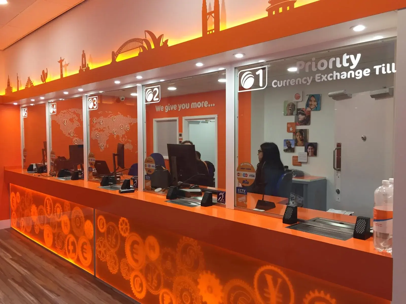 Wide view of the illuminated Ria service counter and branded skyline