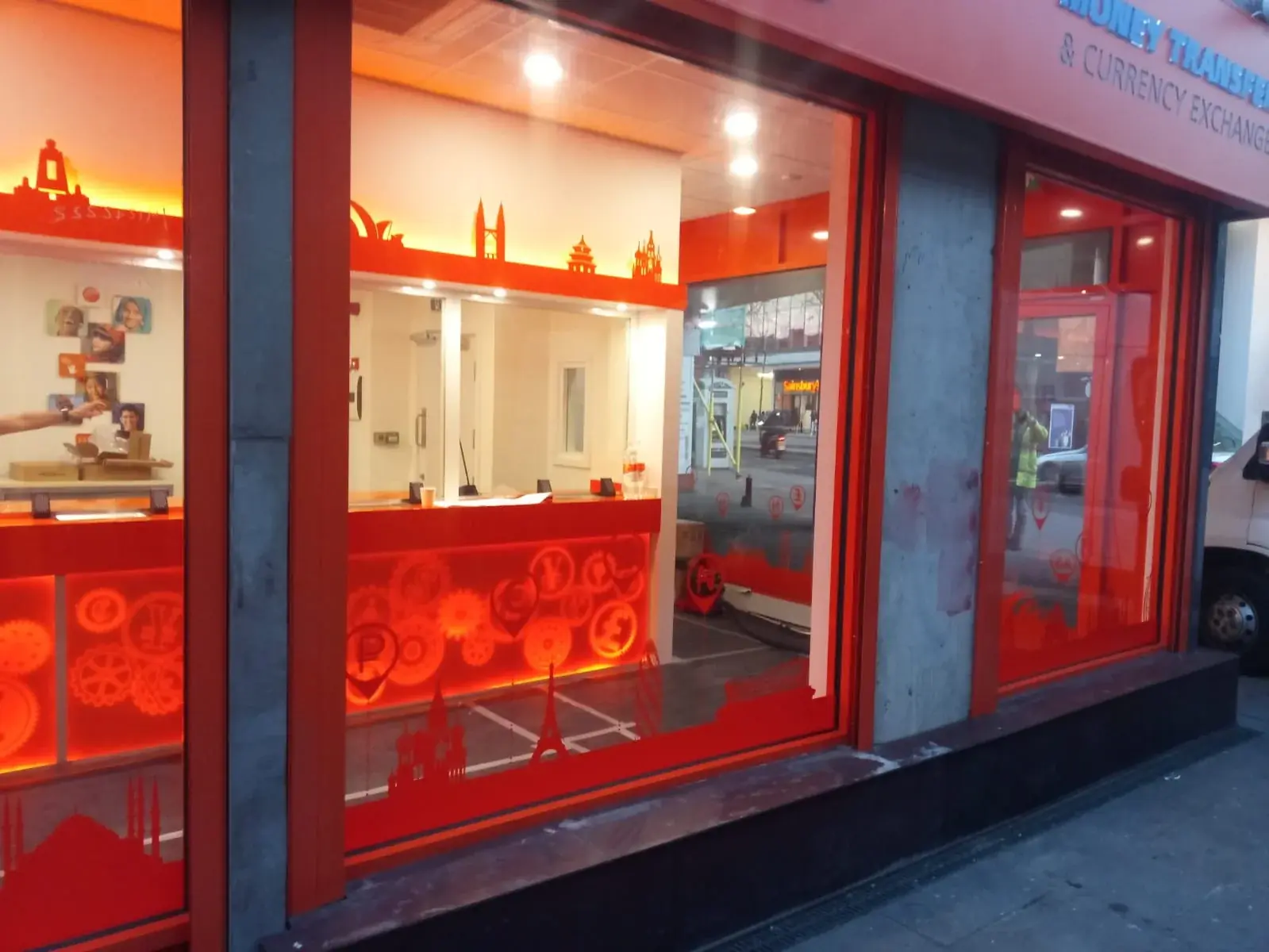 Ria interior service counter visible through the orange branded window graphics