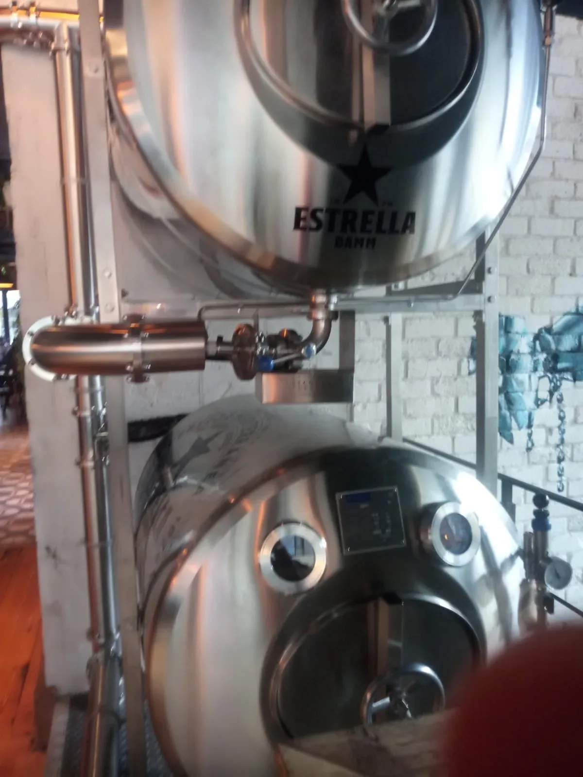 Estrella Damm vinyl logos on stacked stainless tank beer vessels, gallery image 11