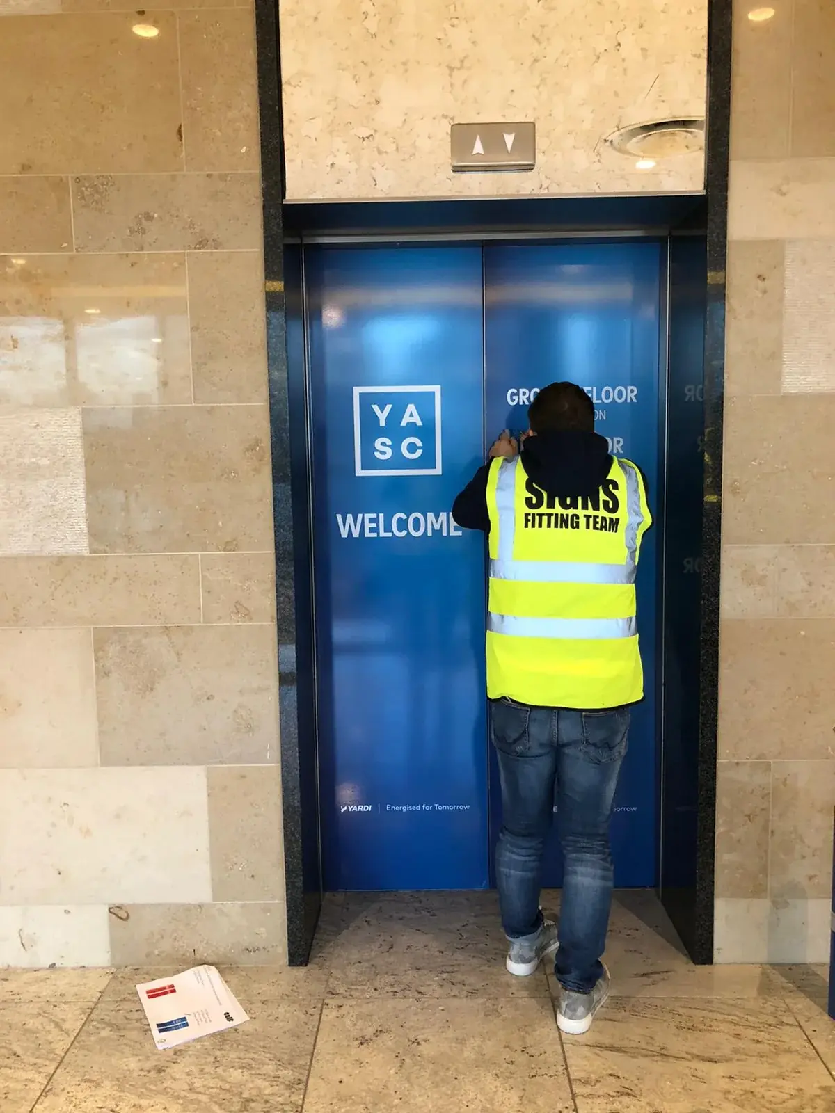 YASC conference branding being installed on lift doors