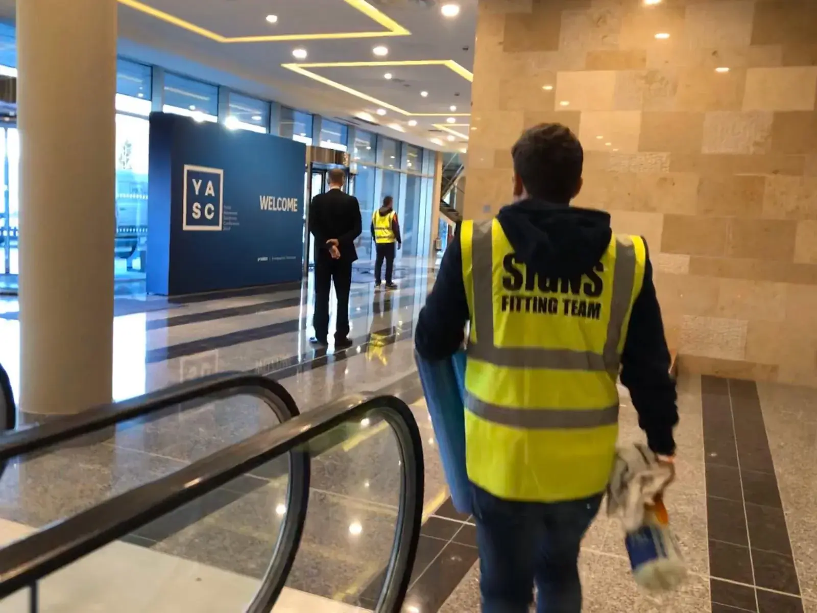 YASC wayfinding graphics being positioned during installation