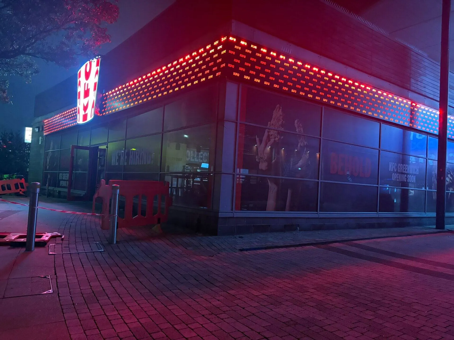 Illuminated commercial signage glowing after dark in London