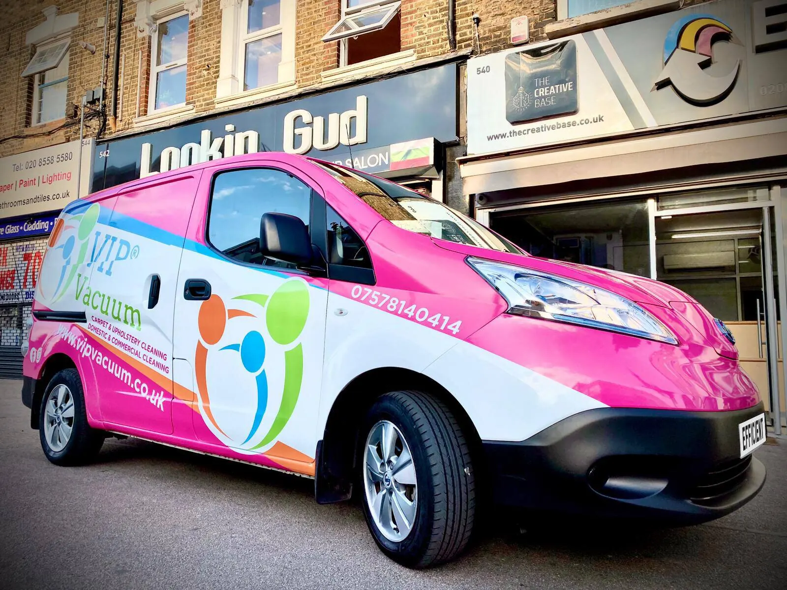 Pink and white VIP Vacuum commercial van wrap