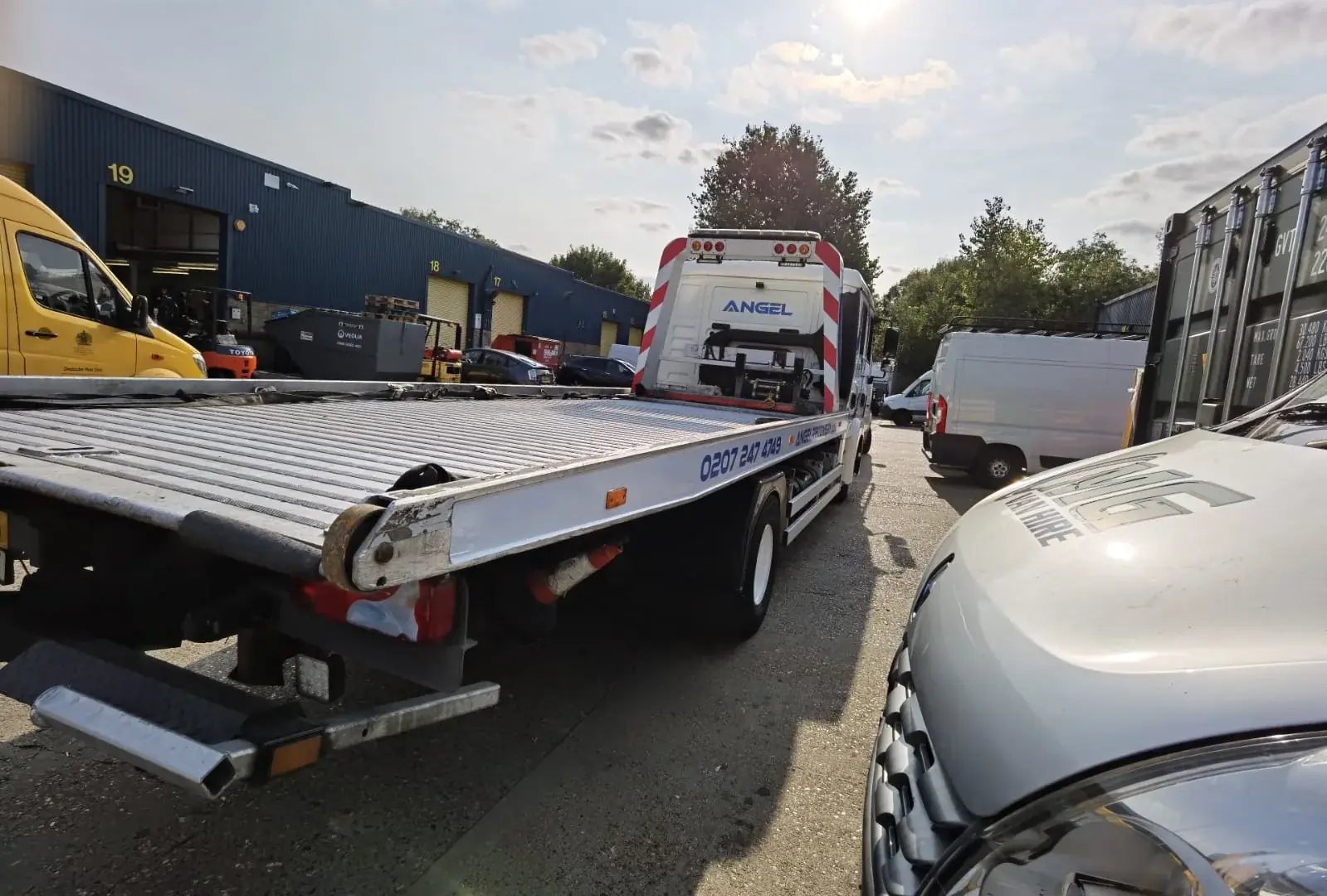 Rear-quarter view of the Angel Recovery truck bed and coordinated vehicle graphics — Truck & Lorry Graphics example for Westminster SW1