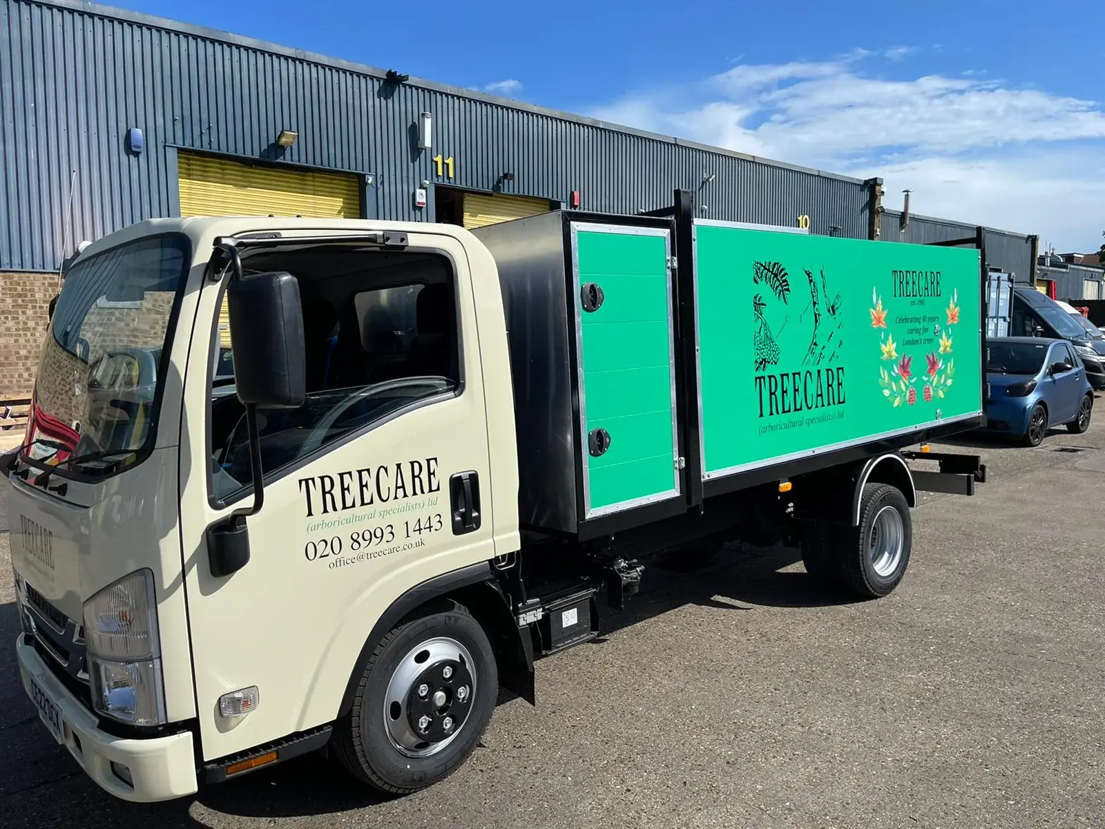 Front-left view of the Treecare truck with cream cab branding and green body graphics — Truck & Lorry Graphics example for Central London