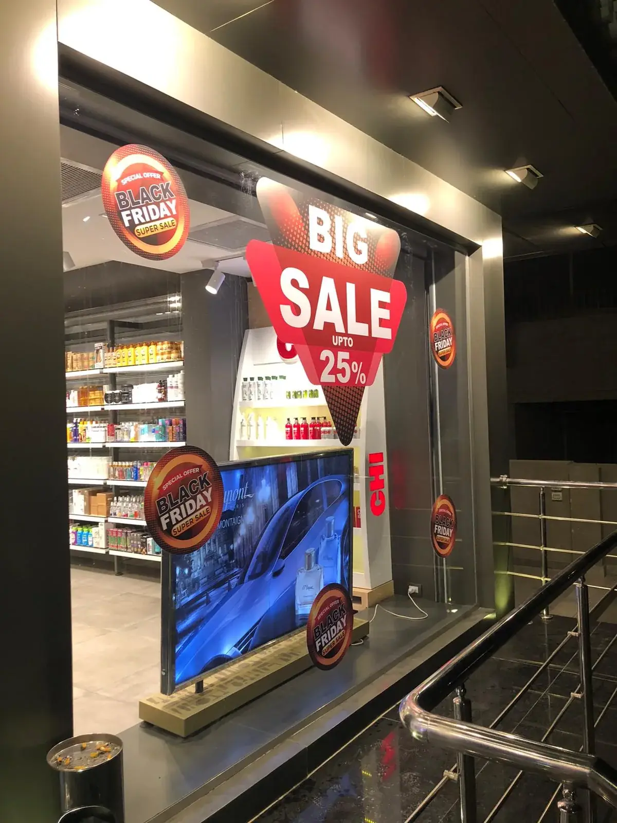 Black Friday promotional stickers and central sale graphic applied across retail glazing