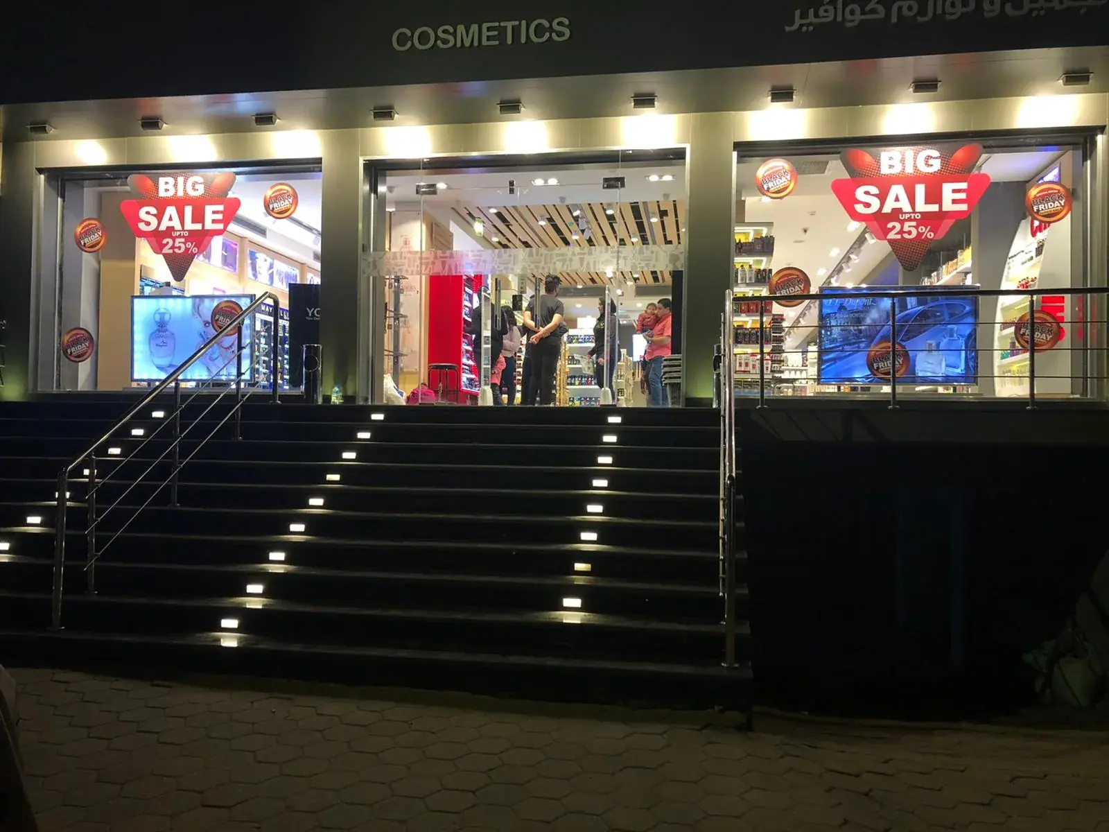 Wide shopfront view showing Black Friday sale graphics across the main window