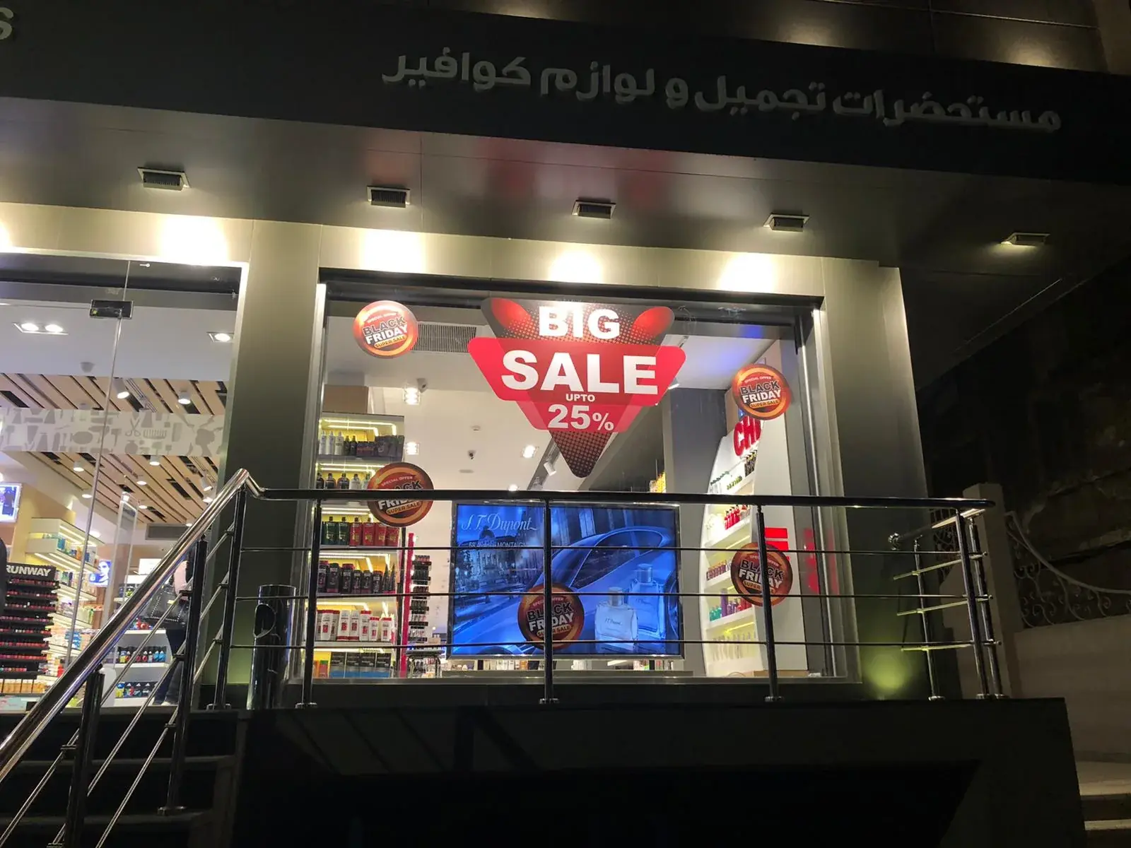 Retail shop window combining Christmas graphics with Black Friday sale artwork