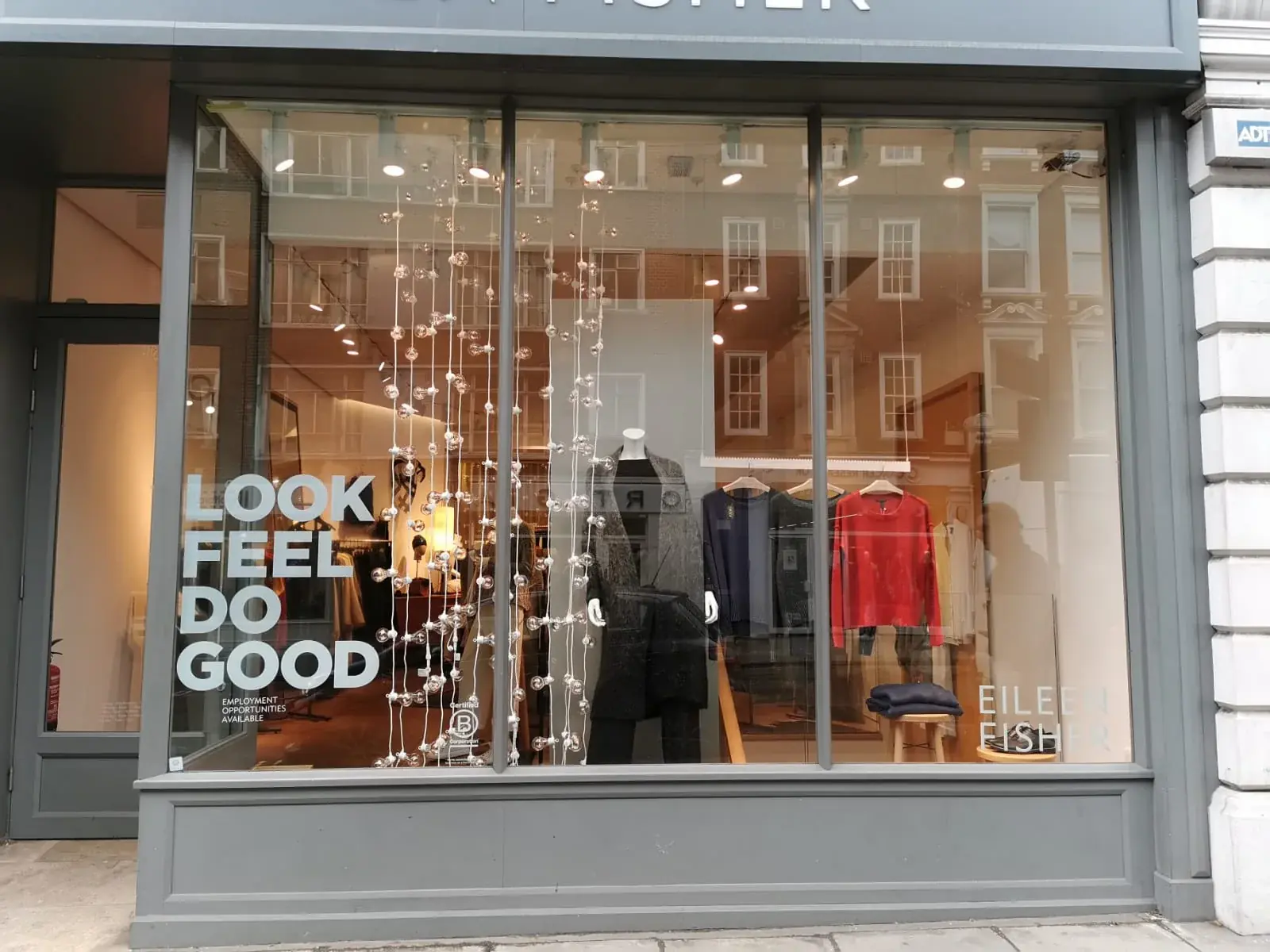 Wide view of Look and Feel campaign graphics installed on shop glazing