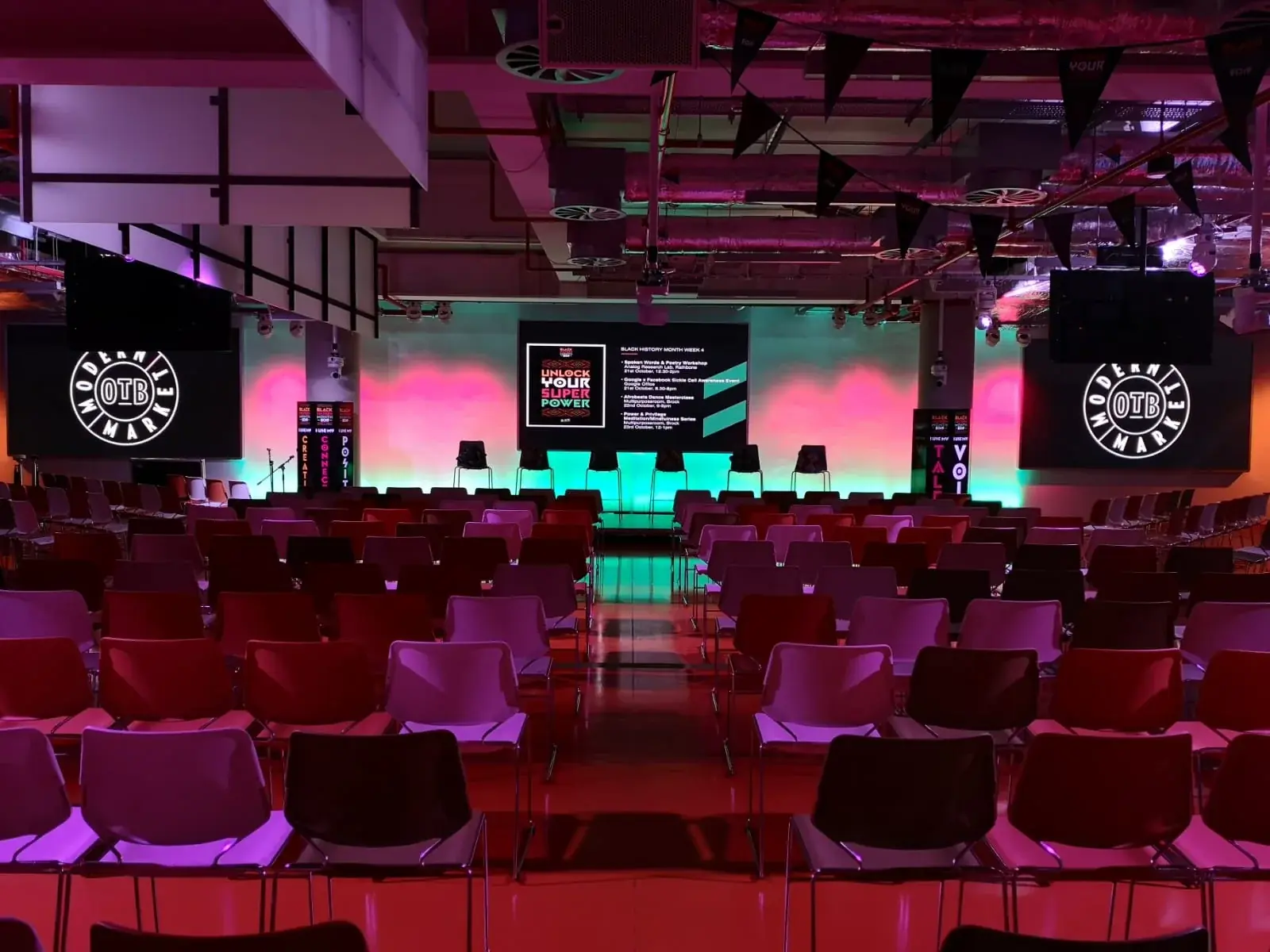 Conference seating facing the stage and coordinated event display columns