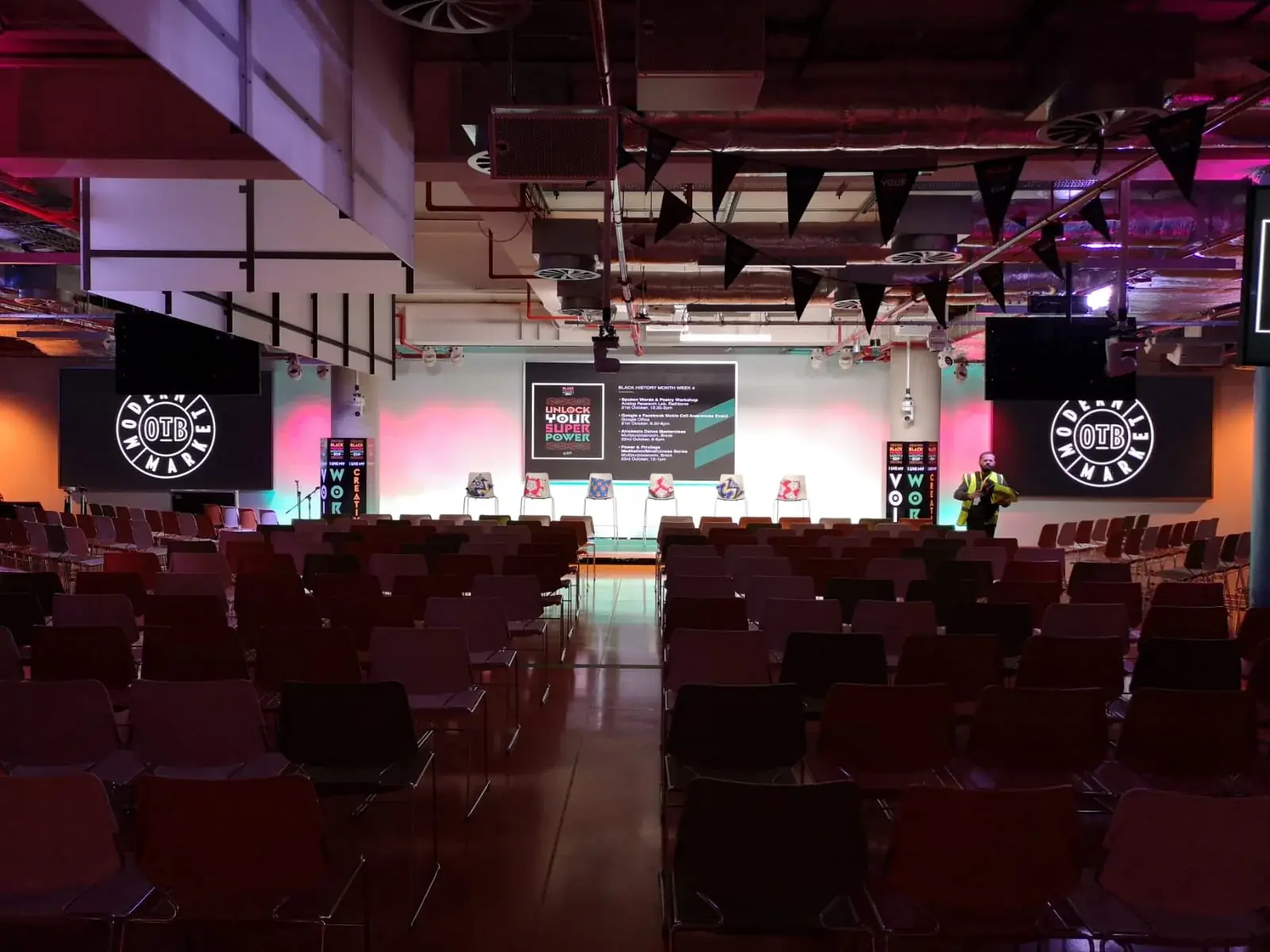 Wide view of the Black History Month conference stage and audience seating