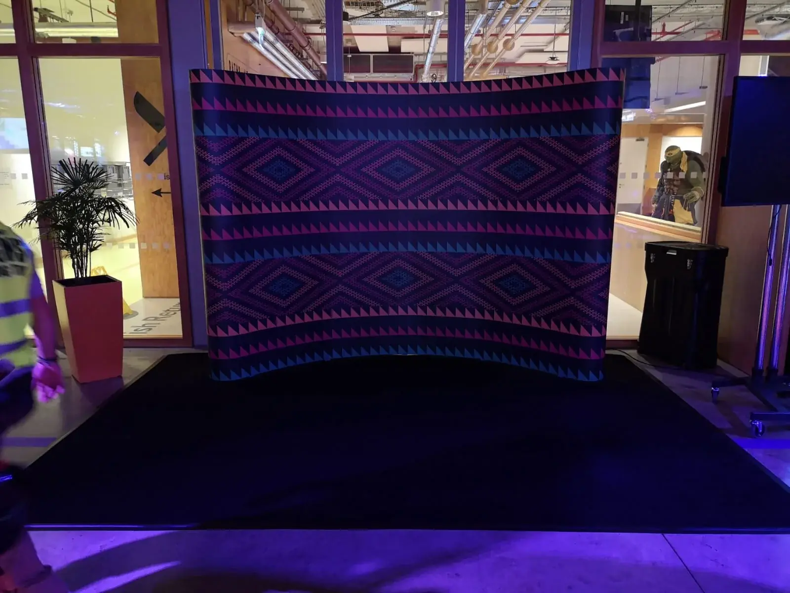 Left view of the curved geometric step-and-repeat event backdrop